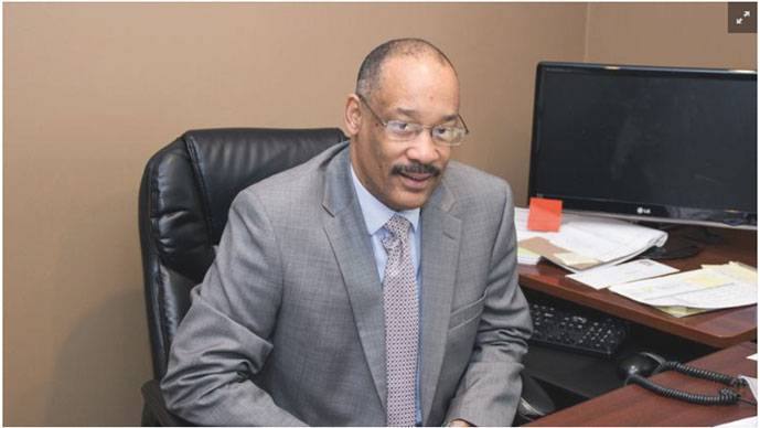 Mr Elmore sitting at his desk